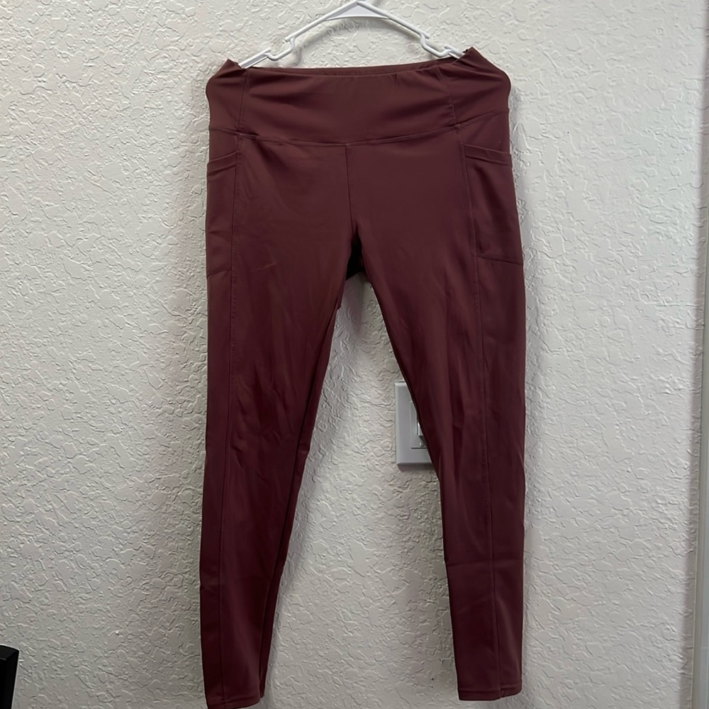 Full length dark pink athletic leggings.